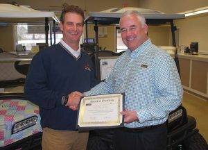 Ocean Lakes Golf Car Manager accepts Club Car Black and Gold Elite award