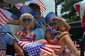 Girls dressed for July 4th on golf car